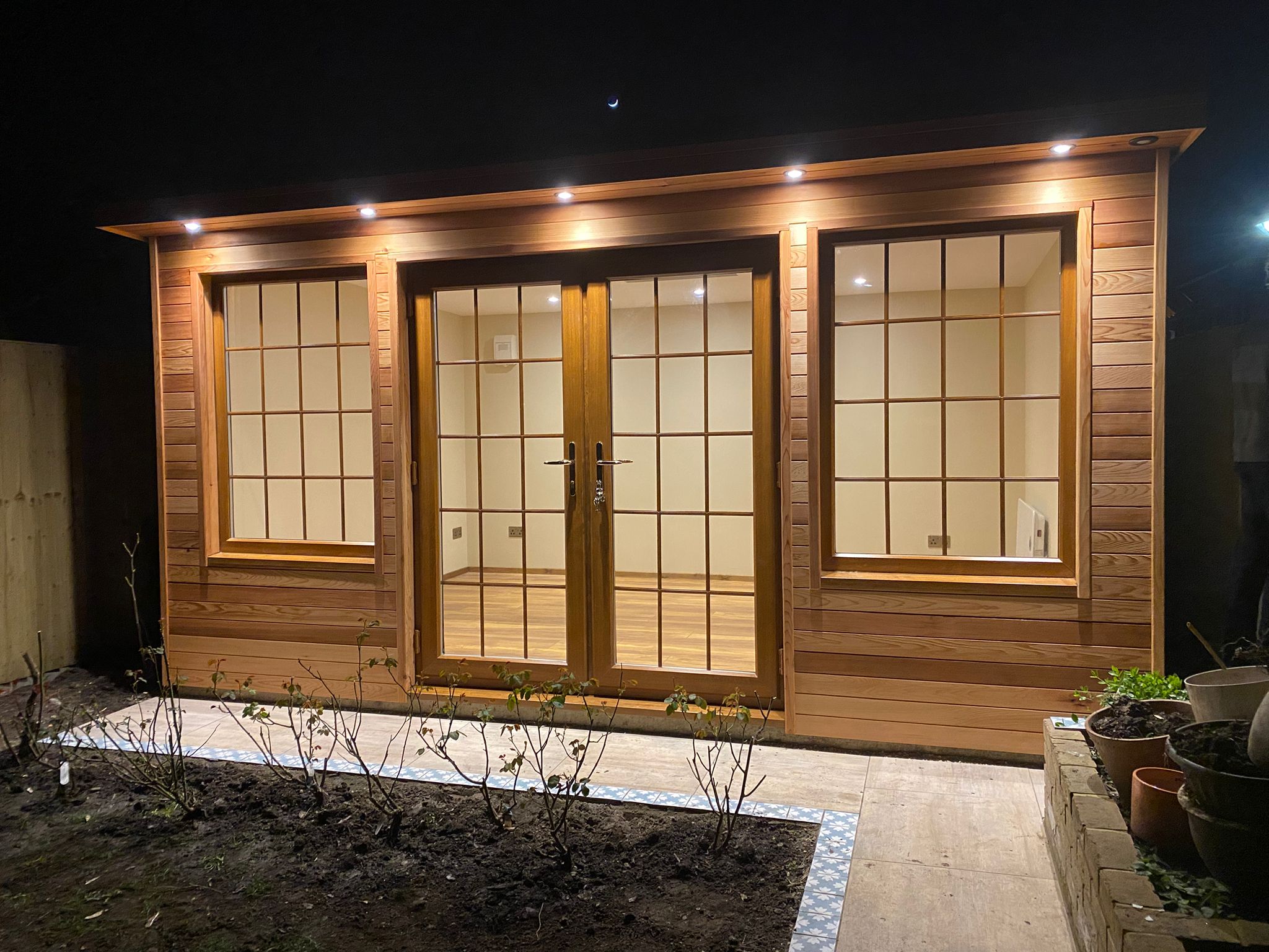Cedar-clad bespoke garden room at night